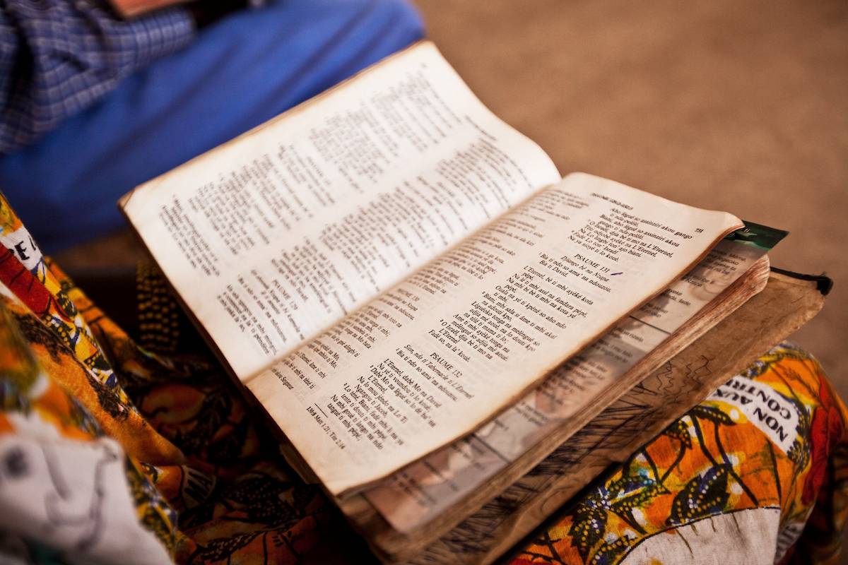 Open bible in lap.